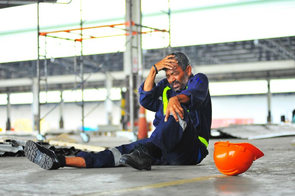 Workers’ Compensation Lawyer in Atlanta | Kaine Law An older worker holds his head after a workplace accident.
