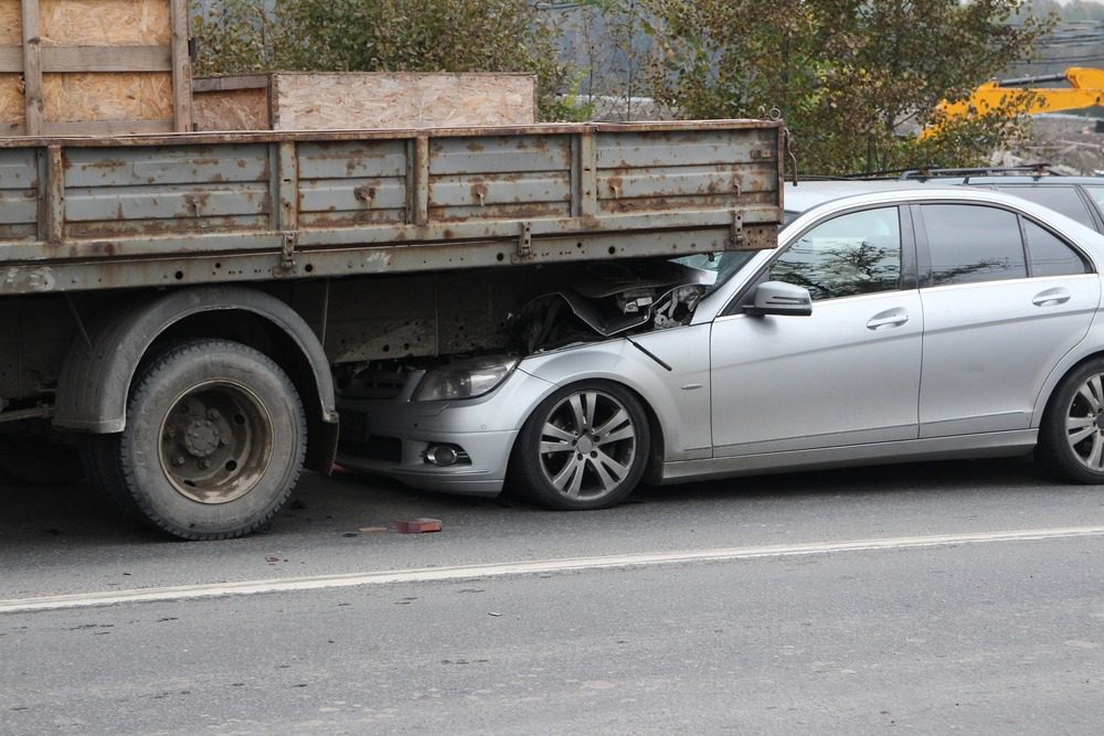 Truck Accident Lawyer in Georgia | No Upfront Fees | Available 24/7 A truck and small passenger vehicle collide on a highway.