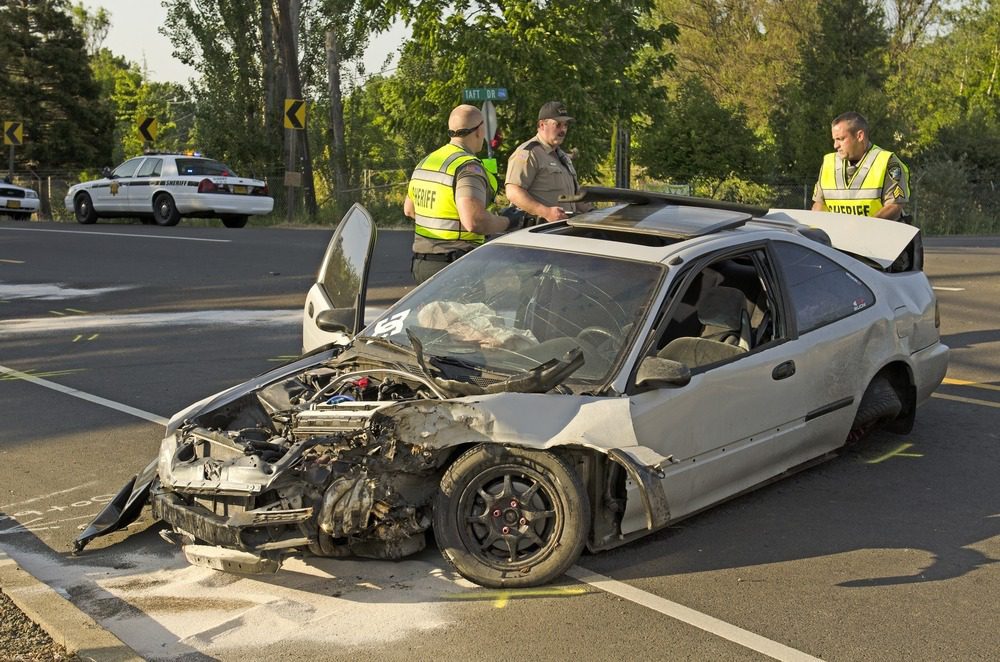 Single-Car Accident Liability | Free Consult | 24/7 Service cop and safety workers examining a wrecked car