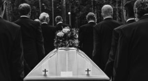 funeral procession with coffin in black and white