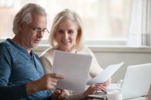 happy middle-aged couple reviewing their finances